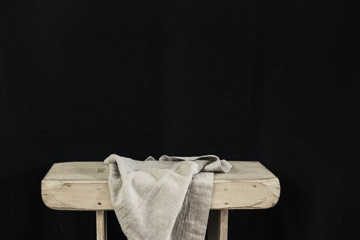 Close-up of textured farmhouse style table runner with embroidered wheat motif